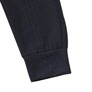 High-quality close-up detail of men's knitted jogger pants cuff with navy jacquard pattern