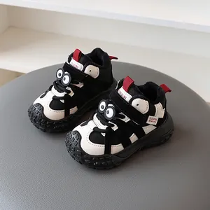Cute cartoon winter children's sneakers with warm fleece lining in black and white