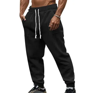 Macro view of men's black knitted texture joggers showing drawstring and pocket details