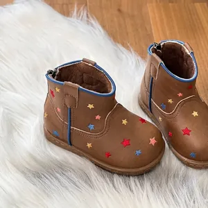 Detailed view of brown leather toddler boots with embroidered colorful stars and lining