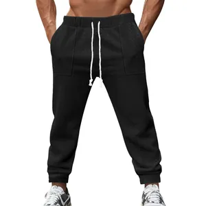 Detailed view of men's black knitted jacquard joggers with adjustable drawstring waist.