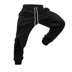Detail of black knitted men's joggers with textured pattern and drawstring waist
