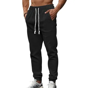Close-up detail of men's black cable knit texture sports joggers with a white drawstring