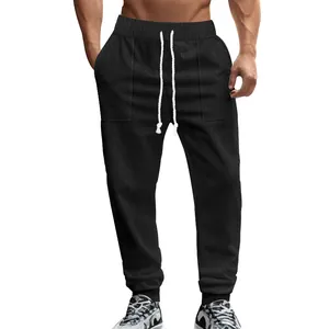 Men's black knitted textured joggers with drawstring waist and athletic fit detail