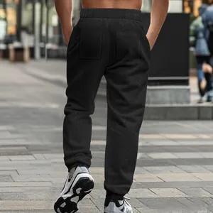 Detailed back view of men's black knit jacquard joggers showing the unique textured fabric pattern