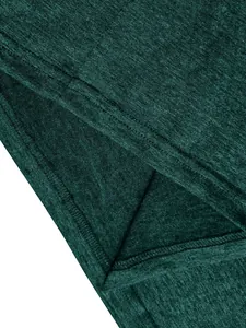 Detail view of dark green heathered fabric texture with double-needle hem stitching
