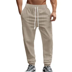 Macro view of men's knit jacquard casual sweatpants with adjustable white drawstring
