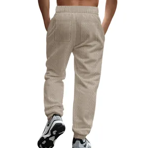 Detailed back view of men's beige cable knit joggers featuring dual rear pockets.