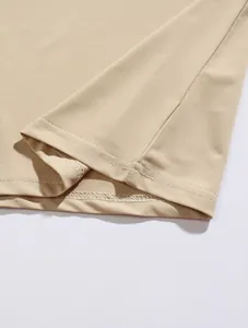 Macro close-up detail of the double-needle hem stitching on a men's beige Polo shirt