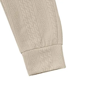 Close-up of textured cable-knit pattern and ribbed cuff on beige men's casual trousers
