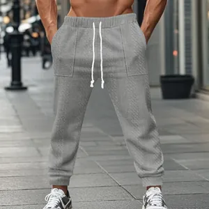 Detailed macro view of grey knitted men's joggers with drawstring