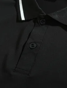 Close-up view of the black breathable polo shirt showing collar detail and buttons