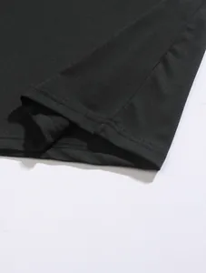 Detailed close-up view of the double-stitched hem and fabric texture of a black men's polo shirt