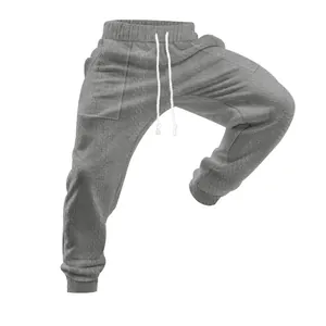 Detail of men's grey knit joggers with textured pattern and adjustable drawstring.
