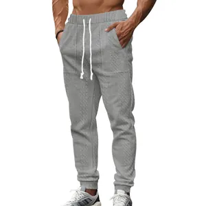 Casual men's grey cable knit joggers featuring drawstring waist and elastic cuffs for comfort