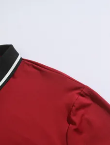 Close-up of red Polo shirt with black jacquard collar and shoulder stitching
