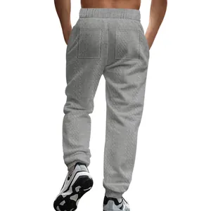Detailed back view of men's grey knitted joggers with textured pattern and elastic waist
