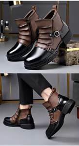 Close-up detail of men's two-tone leather boots with side zipper and stylish metal buckle strap