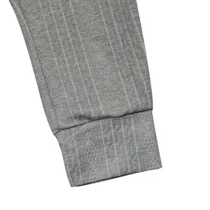 Close-up of grey knitted jogger pants cuff showing detailed cable rib knit texture