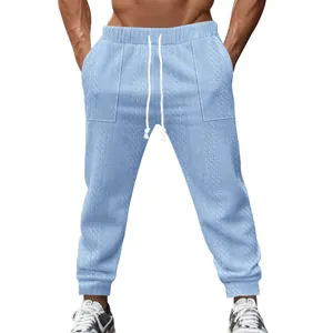 Close-up of cable knit texture on light blue men's joggers with white drawstring