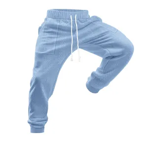 Macro view of light blue knitted drawstring sports trousers showing braided texture