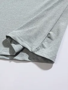 Detailed view of high-quality double-needle stitching on grey breathable polo shirt hem.