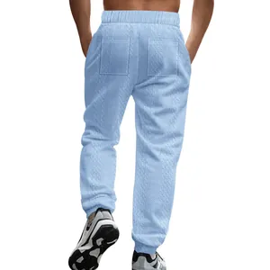 Detailed back view of men's light blue cable knit leisure jogger pants with back pockets