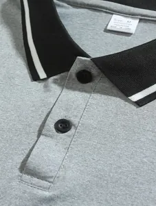 Close-up detail of men's breathable polo shirt with black tipping collar and grey fabric texture