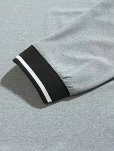 Macro detail view of heather gray shirt sleeve with black and white striped cuff