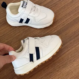 White fleece-lined children's sneakers with blue stripes and soft non-slip soles