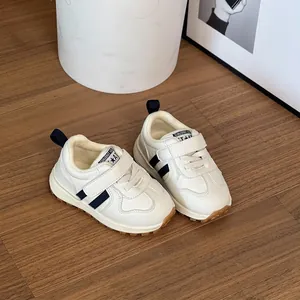 Warm white winter sneakers for children featuring navy stripes and secure velcro strap