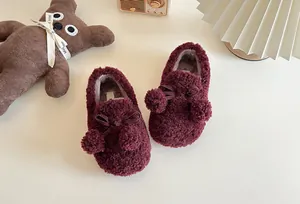 Warm burgundy children's plush loafers featuring cute pom-poms and bow accents for winter