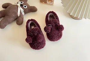 Cute wine red children's fluffy loafers with decorative pom-poms and warm inner lining
