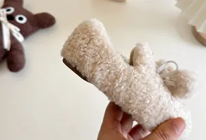 Close-up detail of soft cream fleece lining and texture on children's slip-on winter shoes