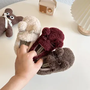 Cozy children's fuzzy slip-on shoes with cute pom-poms and warm fleece lining for winter