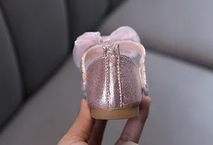 Vue détaillée du talon des chaussures princesse rose à paillettes avec grand nœud