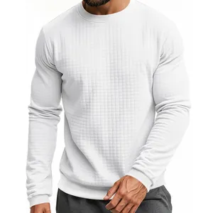 Detail of a men's slim fit waffle knit long sleeve T-shirt in clean white color