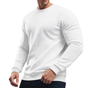 Detail showing the waffle grid texture of a men's white slim-fit crewneck sweater
