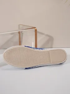 Close-up view of the anti-slip sole on blue and white fly-knit women's shoes