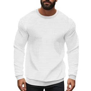 Close-up of men's white long-sleeve knit shirt with small grid pattern texture.