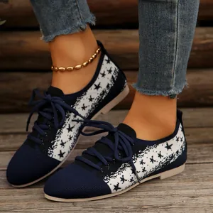 Comfortable navy blue fly-knit women's flats with white star pattern and lace-up design