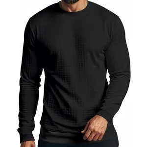 Detail shot of men's black long-sleeve crewneck T-shirt showing small checkered texture.