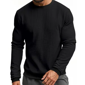 Macro detail of men's slim fit black crew neck sweater showing waffle grid texture