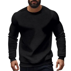 Detailed view of men's slim fit black knit sweater featuring a unique small grid pattern