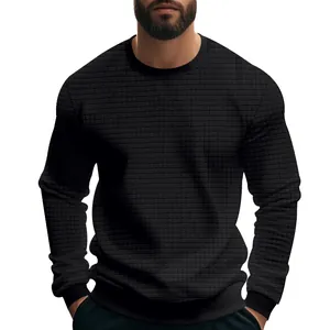 Detail of black men's crew neck sweater with intricate grid texture and slim fit