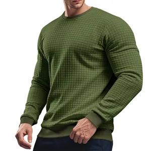 Close-up of olive green long-sleeved knit shirt with square grid pattern and ribbed cuffs