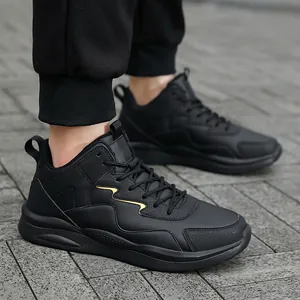Detailansicht schwarzer Outdoor-Sneaker mit goldenem Akzent auf grauem Pflasterstein