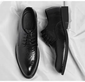 Detailed view of men's vintage black leather dress shoes with hand-scrubbed texture.