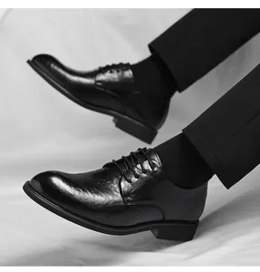 Detail view of men's vintage hand-crinkled black leather formal shoes with pointed toe