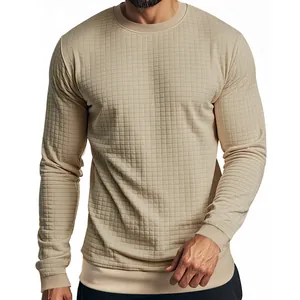 Close-up shot of men's slim-fit beige long-sleeved T-shirt with a textured grid pattern.